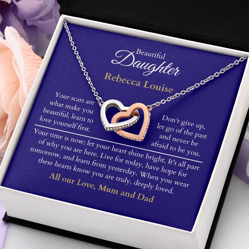 Personalised Beautiful Daughter Interlocking Hearts Necklace, two heart pendants embellished with CZ crystals High quality polished surgical steel and rose gold finish. With a Heartfelt message starting with: Your scars are what make you beautiful.