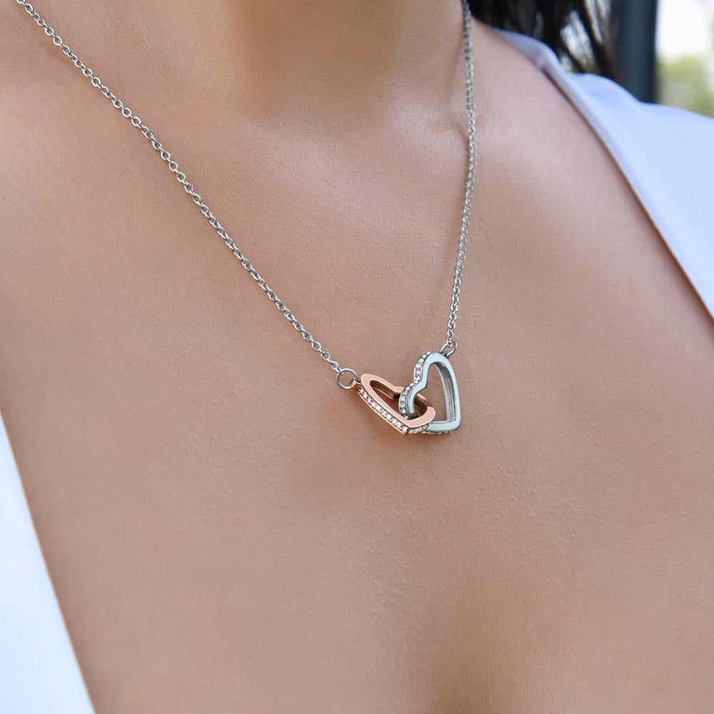 To Our Daughter, two lovely interlocking heart pendants embellished with CZ crystals. High quality polished surgical steel and rose gold finish. Love Mom & Dad