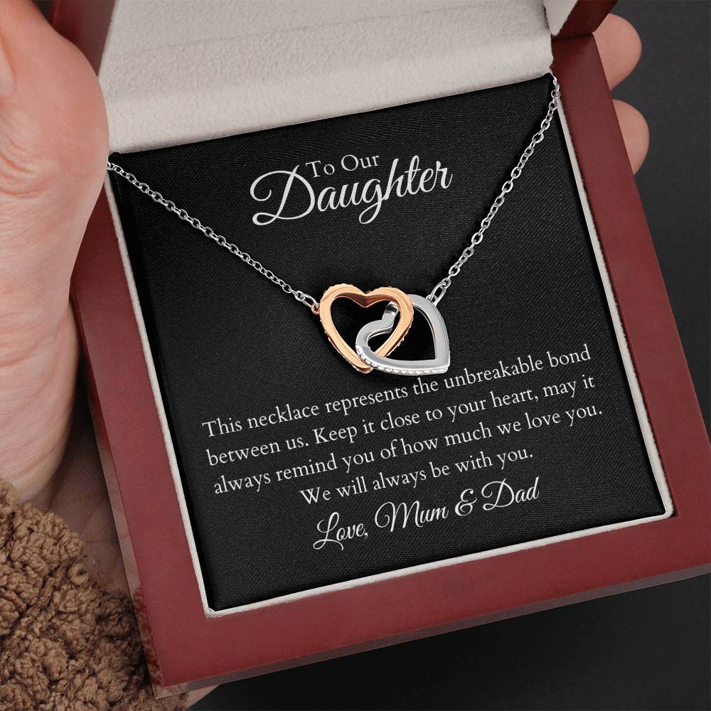 To Our Daughter, two lovely interlocking heart pendants embellished with CZ crystals. High quality polished surgical steel and rose gold finish.