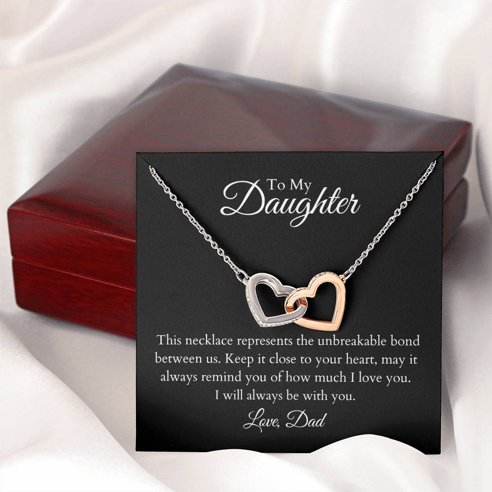 To My Daughter, two lovely interlocking heart pendants embellished with CZ crystals. High quality polished surgical steel and rose gold finish.