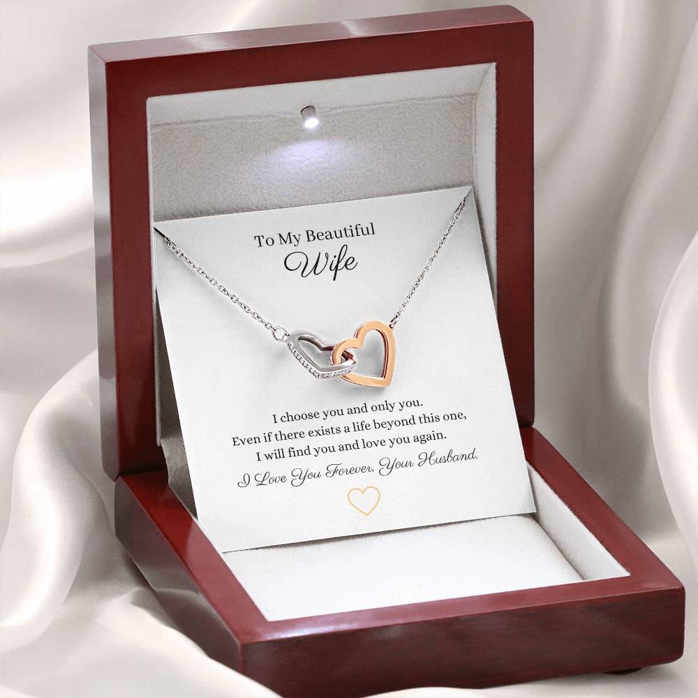 Two lovely interlocking heart pendants embellished with CZ crystals. High quality polished surgical steel and rose gold finish or 18k yellow gold finish necklace.