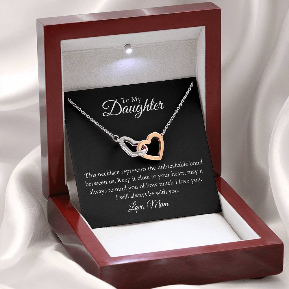 To My Daughter, two lovely interlocking heart pendants embellished with CZ crystals. High quality polished surgical steel and rose gold finish.