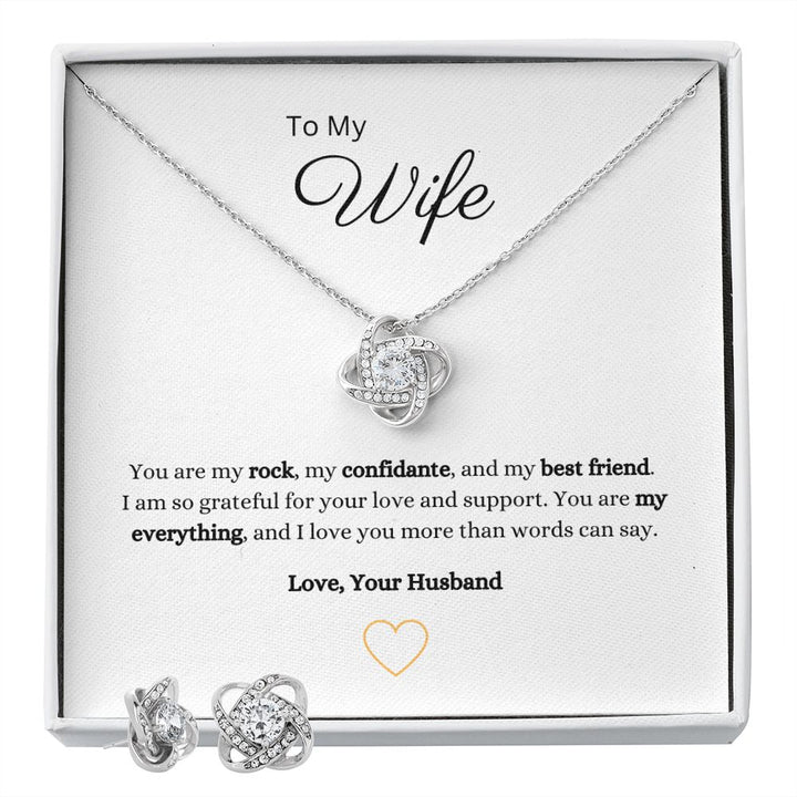 Gorgeous Love Knot Earring & Necklace Set. A symbol of never ending love, crafted with brilliant 14k white gold over stainless steel, surrounding a dazzling 6mm cubic zirconia crystal.