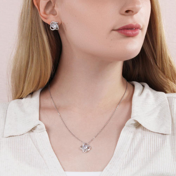 Gorgeous Love Knot Earring & Necklace Set. A symbol of never ending love, crafted with brilliant 14k white gold over stainless steel, surrounding a dazzling 6mm cubic zirconia crystal.