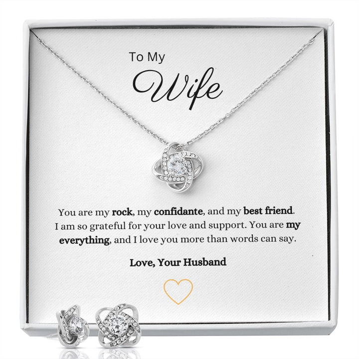 Gorgeous Love Knot Earring & Necklace Set. A symbol of never ending love, crafted with brilliant 14k white gold over stainless steel, surrounding a dazzling 6mm cubic zirconia crystal.