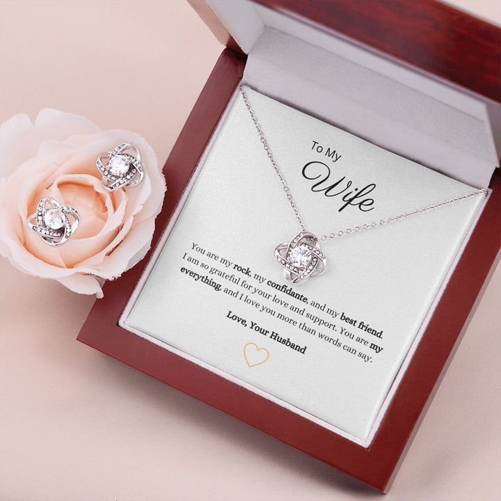 Gorgeous Love Knot Earring & Necklace Set. A symbol of never ending love, crafted with brilliant 14k white gold over stainless steel, surrounding a dazzling 6mm cubic zirconia crystal.