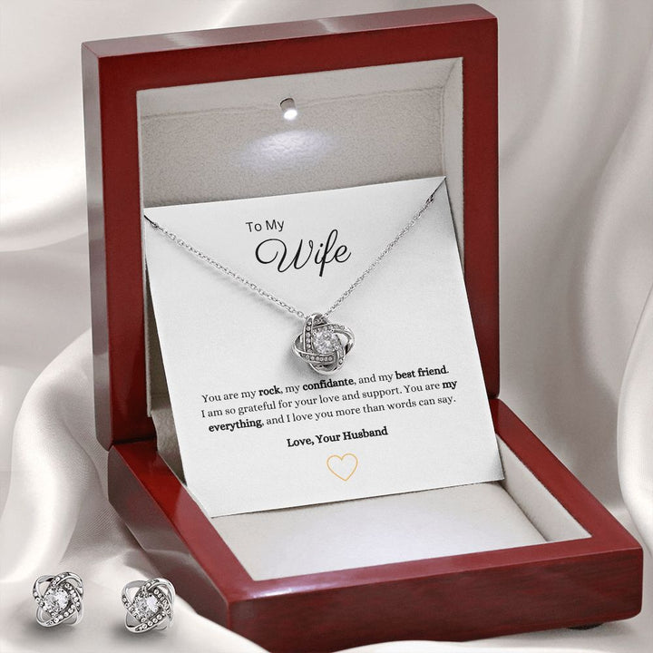 Gorgeous Love Knot Earring & Necklace Set. A symbol of never ending love, crafted with brilliant 14k white gold over stainless steel, surrounding a dazzling 6mm cubic zirconia crystal.