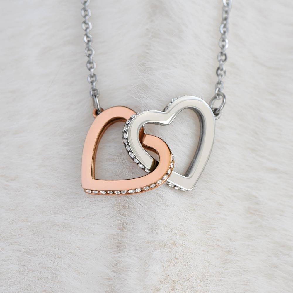 Two lovely interlocking heart pendants embellished with CZ crystals. High quality polished surgical steel and rose gold finish or 18k yellow gold finish Pendant.